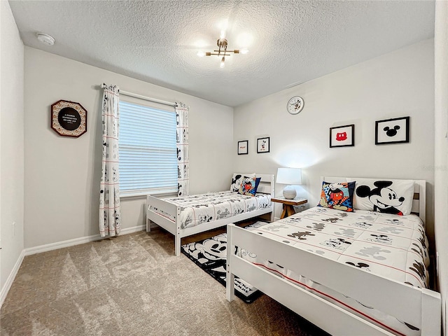 bedroom featuring light colored carpet, a textured ceiling, and an inviting chandelier