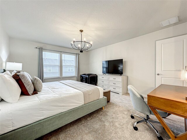 carpeted bedroom featuring a chandelier and a textured ceiling