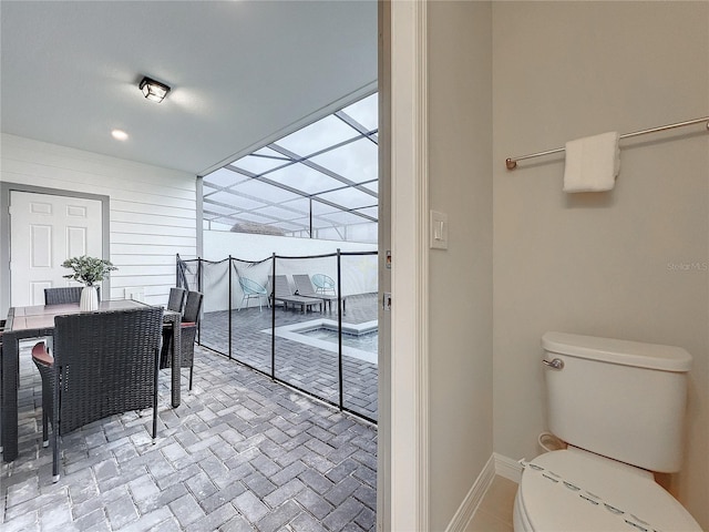 interior space with toilet and wooden walls