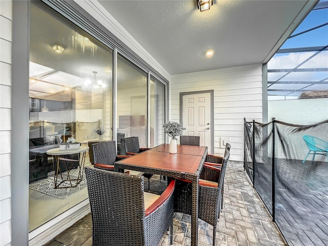 sunroom featuring a chandelier