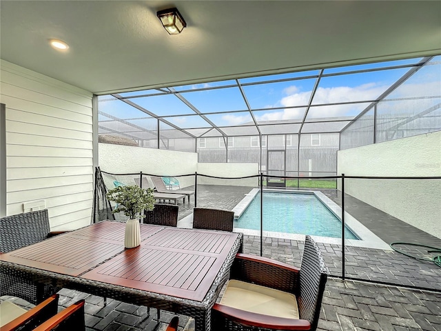 view of swimming pool featuring a lanai and a patio