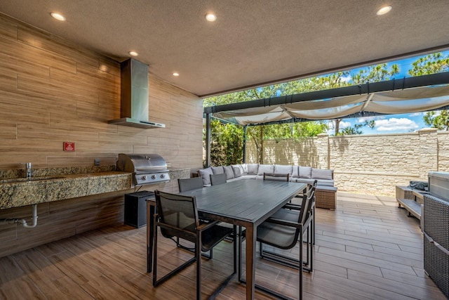 view of patio / terrace featuring area for grilling, sink, and exterior kitchen