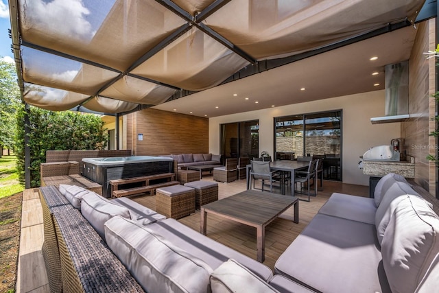 view of patio / terrace featuring an outdoor hangout area and a hot tub