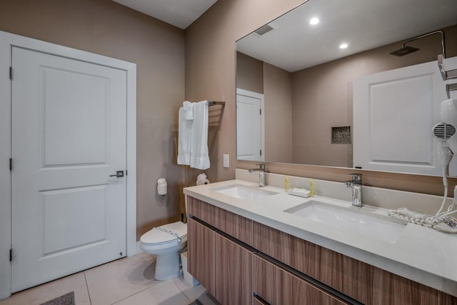 bathroom featuring tile patterned flooring, vanity, and toilet