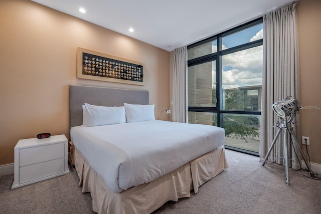 bedroom with access to outside and light colored carpet