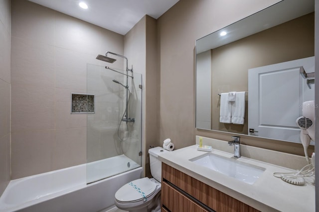 full bathroom featuring vanity, toilet, and tiled shower / bath