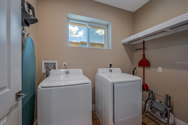 washroom with hardwood / wood-style flooring and independent washer and dryer