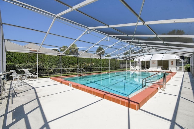 view of swimming pool with a lanai and a patio area