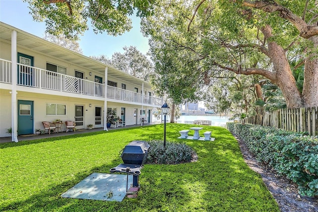 view of home's community with a lawn and a patio