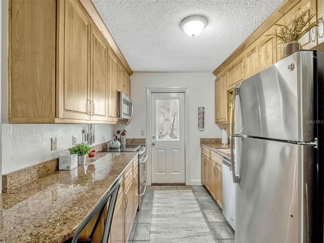 kitchen featuring stone countertops, a textured ceiling, appliances with stainless steel finishes, and light tile patterned flooring