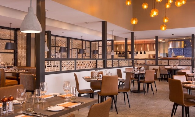 dining area featuring a towering ceiling