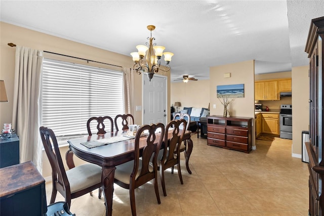 tiled dining area featuring a textured ceiling and ceiling fan with notable chandelier