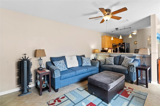 tiled living room with ceiling fan