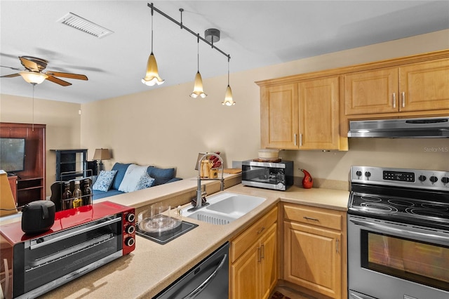 kitchen featuring ceiling fan, sink, stainless steel appliances, and decorative light fixtures