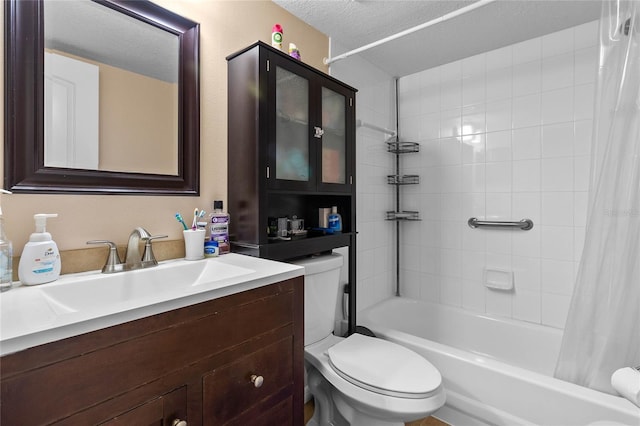 full bathroom with toilet, vanity, a textured ceiling, and shower / tub combo with curtain