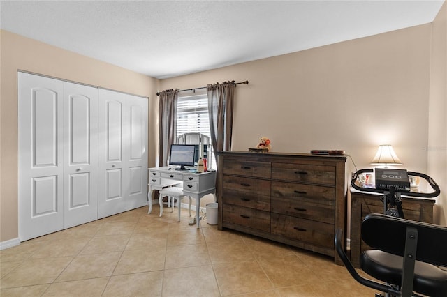 tiled home office with a textured ceiling