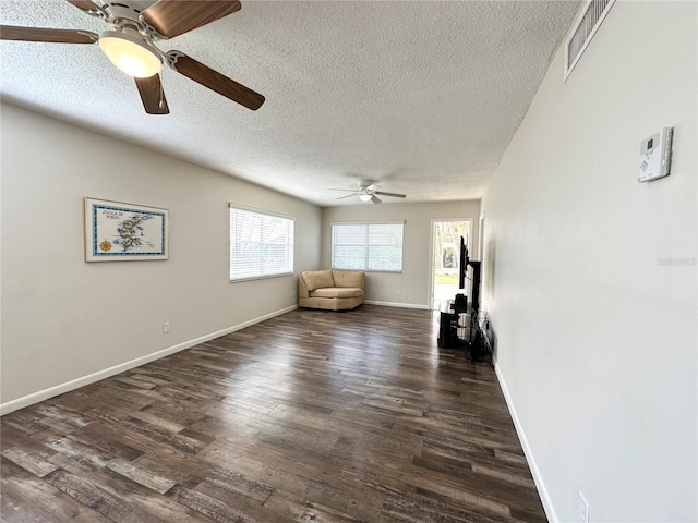 230 Cape Shores Cir Unit 17A, Cape Canaveral, FL 32920 - living area featuring ceiling fan, a textured ceiling, and dark wood finished floors
