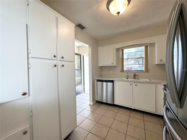 230 Cape Shores Cir Unit 17A, Cape Canaveral, FL 32920 - kitchen featuring stainless steel appliances, white cabinetry, light countertops, and light tile patterned floors