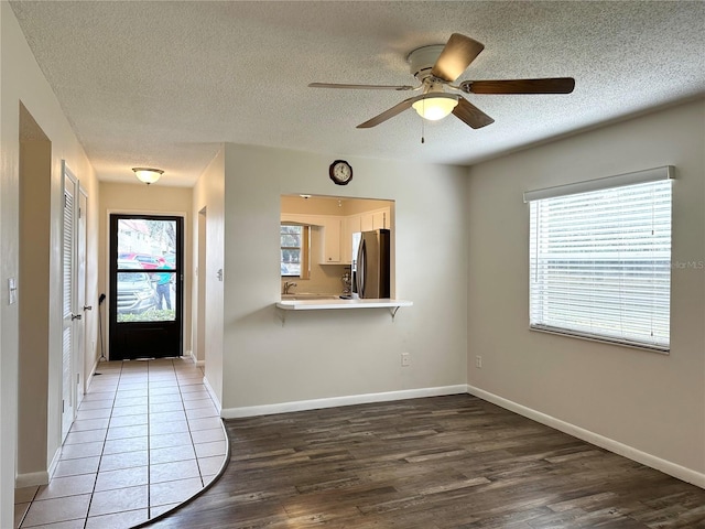 230 Cape Shores Cir Unit 17A, Cape Canaveral, FL 32920 - entrance foyer with wood finished floors, a textured ceiling, and a ceiling fan