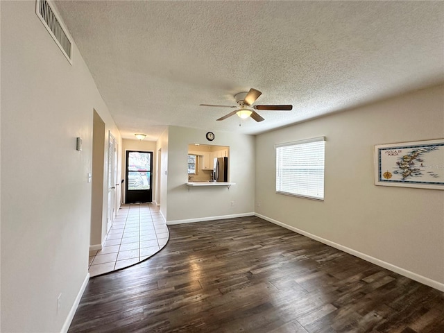 230 Cape Shores Cir Unit 17A, Cape Canaveral, FL 32920 - unfurnished living room with wood finished floors, healthy amount of natural light, a textured ceiling, and ceiling fan