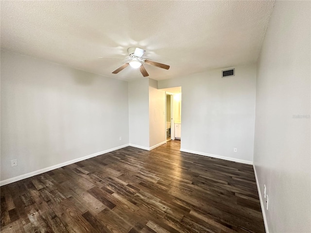 unfurnished room with ceiling fan, dark wood-type flooring, and a textured ceiling