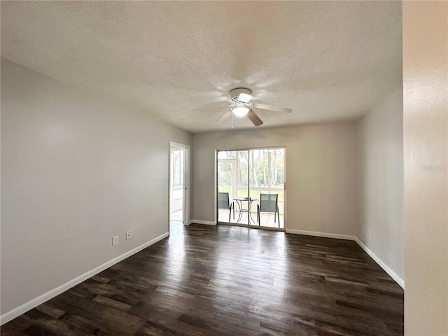 empty room featuring a textured ceiling, ceiling fan, and dark wood-type flooring