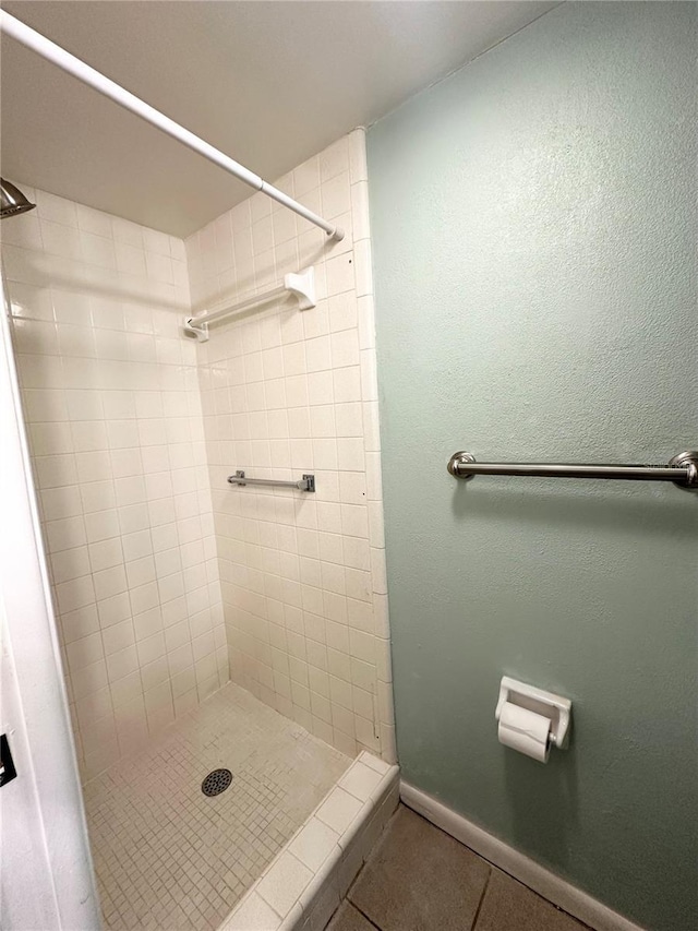 bathroom featuring a tile shower and tile patterned floors