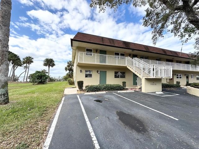 230 Cape Shores Cir Unit 17A, Cape Canaveral, FL 32920 - view of property featuring uncovered parking and stairway