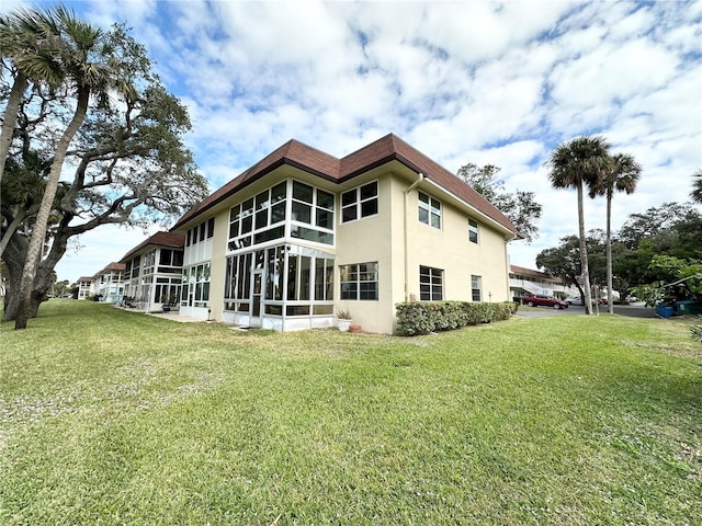 rear view of property with a yard