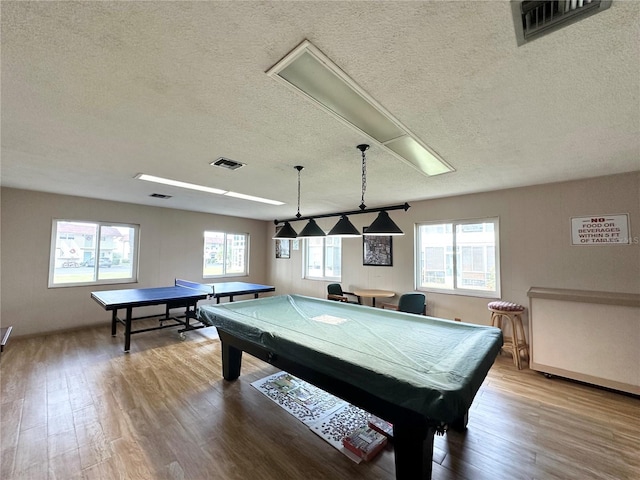 playroom with wood-type flooring, a textured ceiling, and pool table