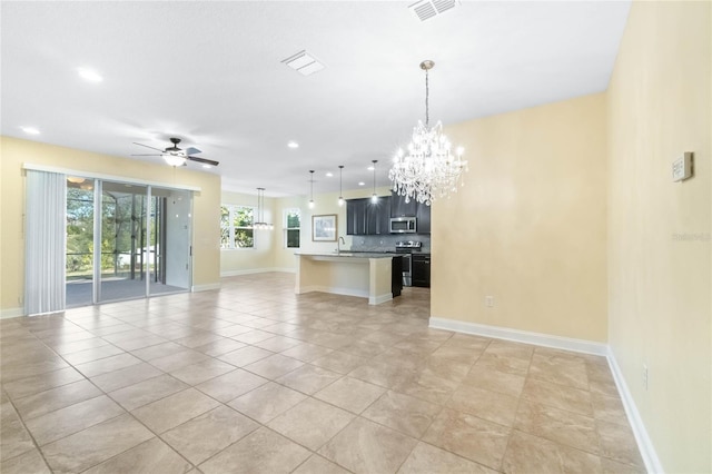 interior space featuring sink, light tile patterned floors, and ceiling fan with notable chandelier