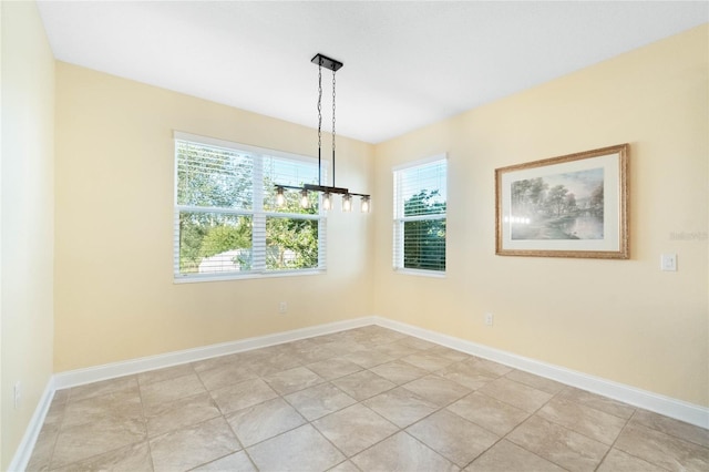 unfurnished dining area featuring light tile patterned floors