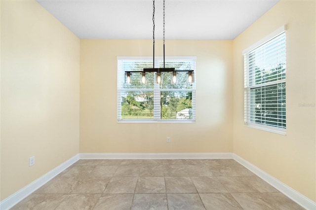 unfurnished dining area featuring light tile patterned flooring