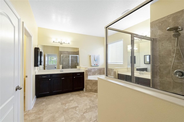 bathroom with vanity and independent shower and bath