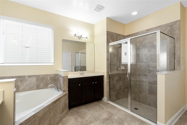 bathroom with tile patterned flooring, vanity, and separate shower and tub