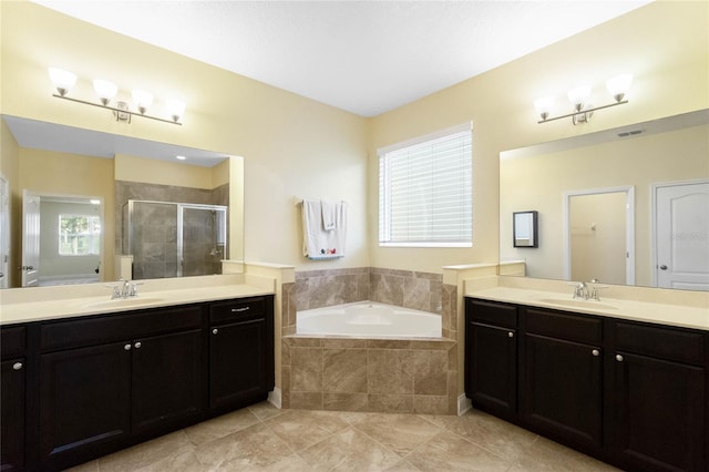 bathroom featuring tile patterned flooring, vanity, and separate shower and tub