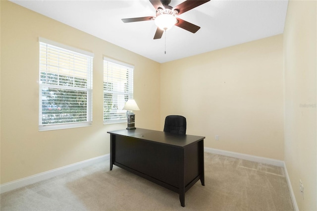 carpeted office featuring ceiling fan