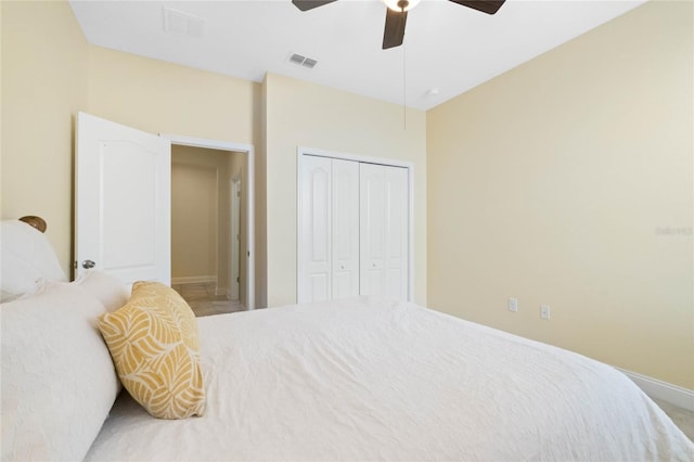 carpeted bedroom with ceiling fan and a closet