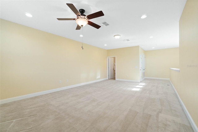 carpeted spare room with ceiling fan