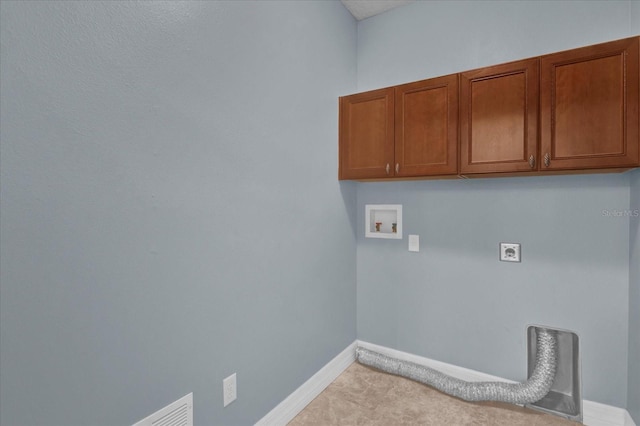 clothes washing area with electric dryer hookup, cabinets, and hookup for a washing machine