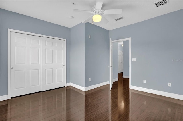 unfurnished bedroom featuring ceiling fan, dark hardwood / wood-style floors, and a closet