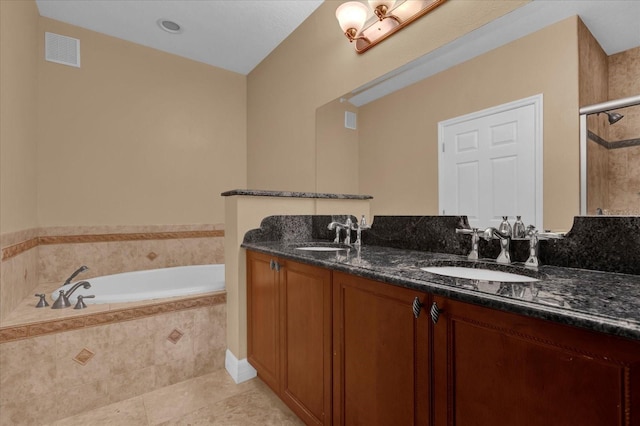 bathroom featuring tile patterned floors, vanity, and plus walk in shower