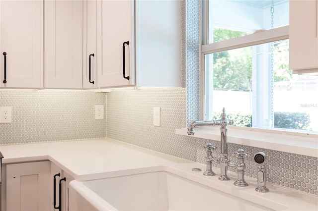 2260 Mulbry Dr, Winter Park, FL 32789 - kitchen with a sink, decorative backsplash, white cabinetry, and light countertops