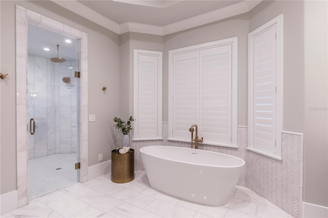 2260 Mulbry Dr, Winter Park, FL 32789 - bathroom featuring a shower stall, a freestanding tub, and wainscoting