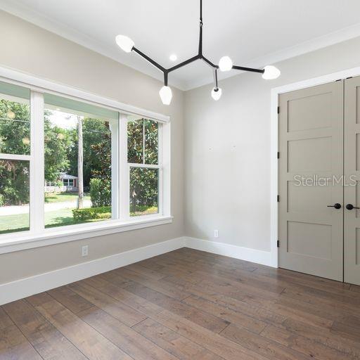2260 Mulbry Dr, Winter Park, FL 32789 - unfurnished room with baseboards, dark wood-style floors, and ornamental molding