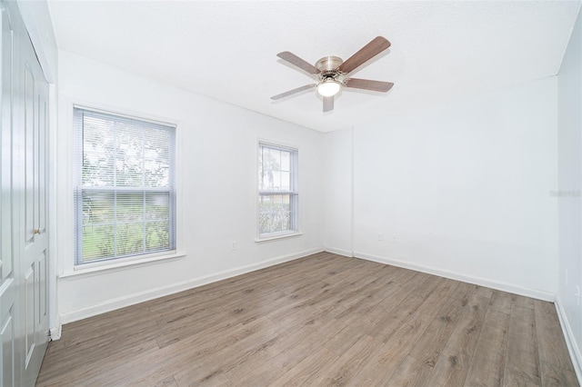 spare room featuring ceiling fan and light hardwood / wood-style floors