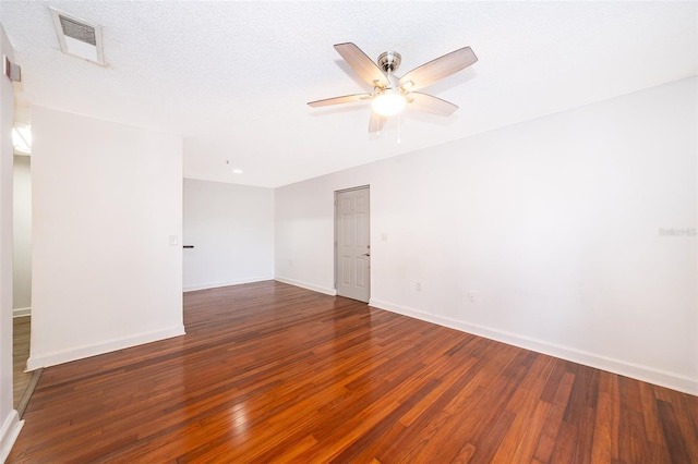 empty room featuring a textured ceiling, ceiling fan, and dark hardwood / wood-style floors