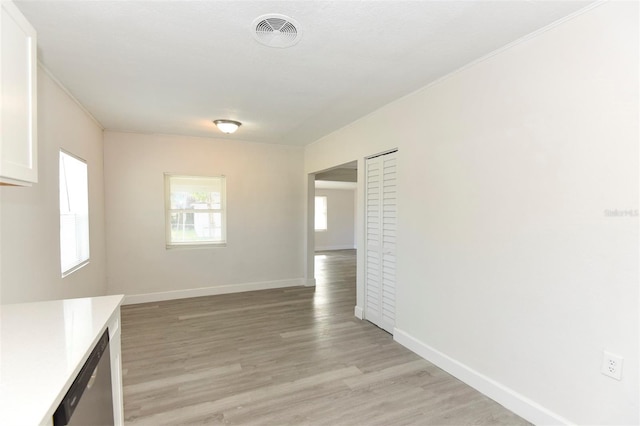 unfurnished room with baseboards, visible vents, and light wood-style floors