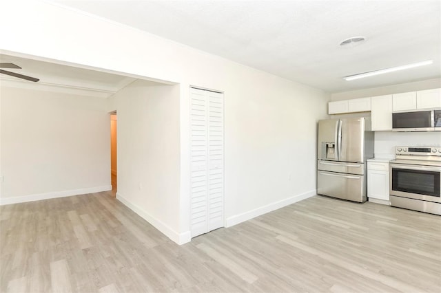 kitchen featuring appliances with stainless steel finishes, white cabinets, visible vents, and light wood finished floors