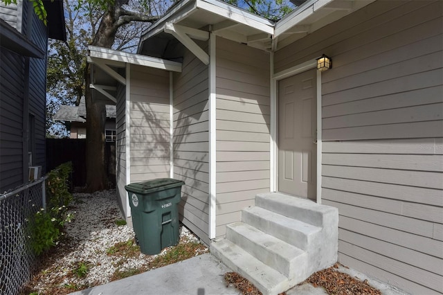 view of exterior entry with fence